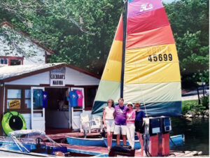 Jimmy and Libby Cochran and two other women standing and posing for a photo on the dock of Cochran's Marina.